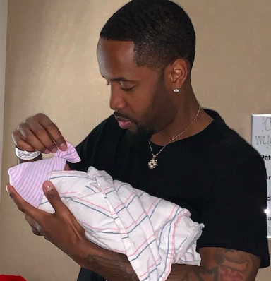 New father Safaree holding his baby girl at the hospital, shrtly after his wife Erica Meena gave birth. 